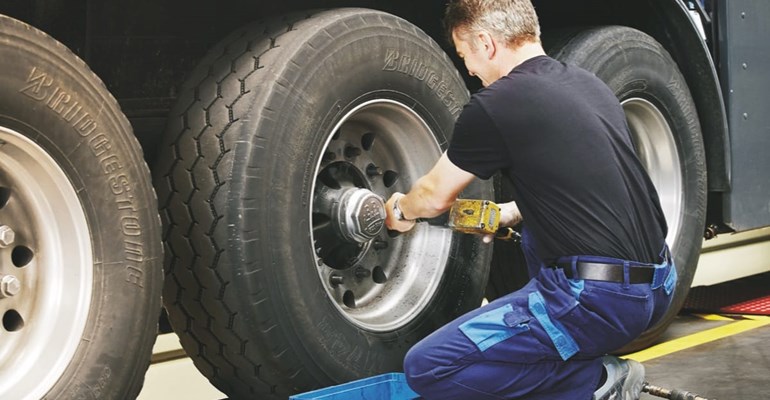 Man changing truck tyre